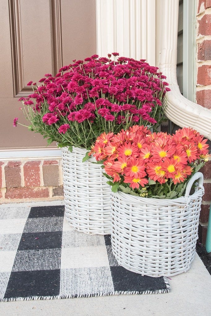 fall porch decor white baskets with flowers inside on the porch