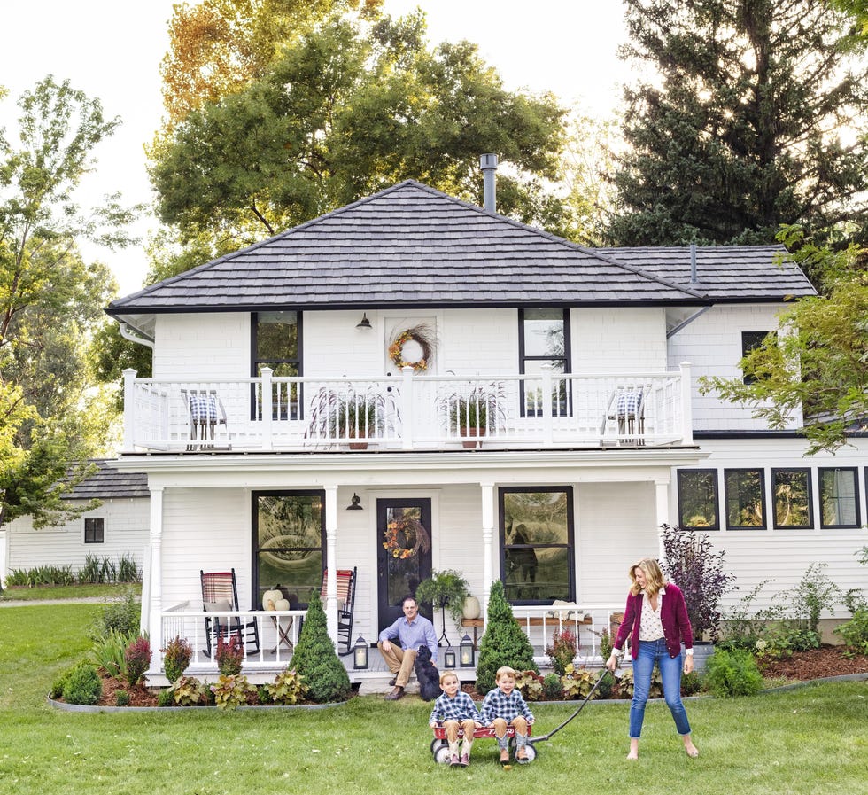 double porch decorated for fall with grapevine wreaths and white pumpkins