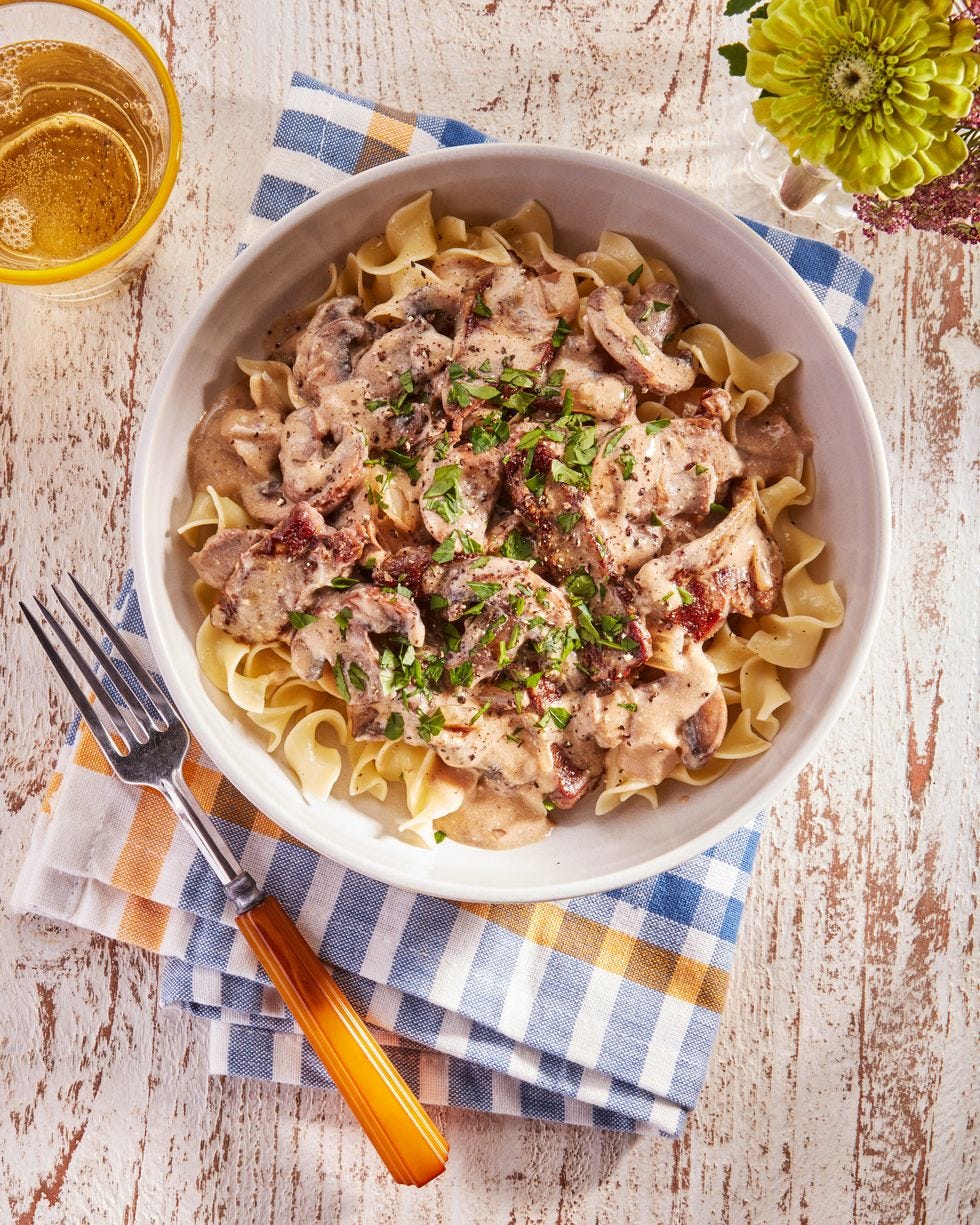 30 minute beef stroganoff in a white bowl with a fork