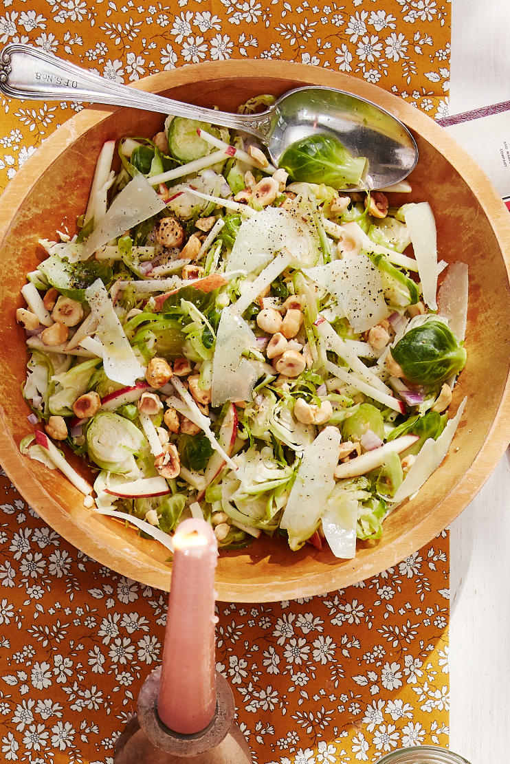 brussels sprouts salad in a wooden bowl with a fork
