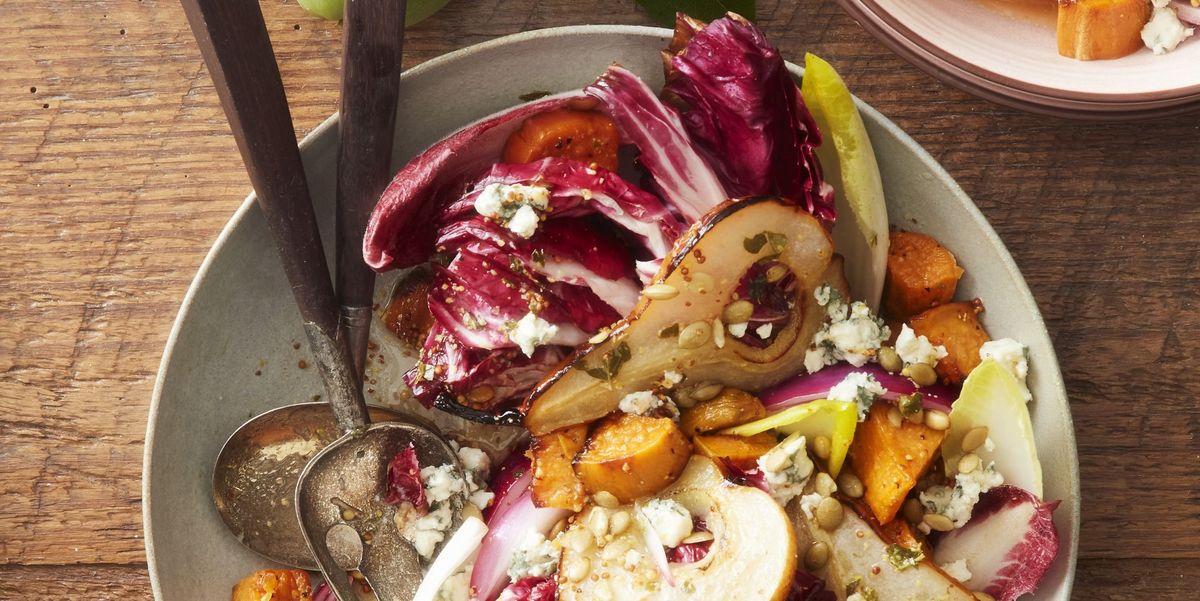 roasted pear sweet potato and radicchio salad in a bowl with silverware on a table