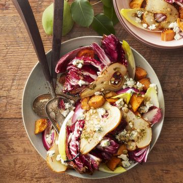 roasted pear sweet potato and radicchio salad in a bowl with silverware on a table