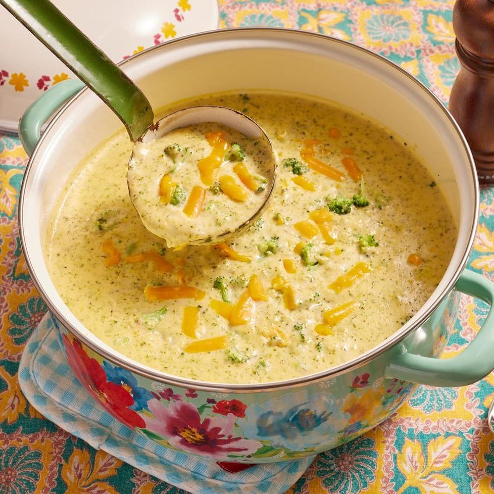 broccoli cheese soup in floral pot with ladle