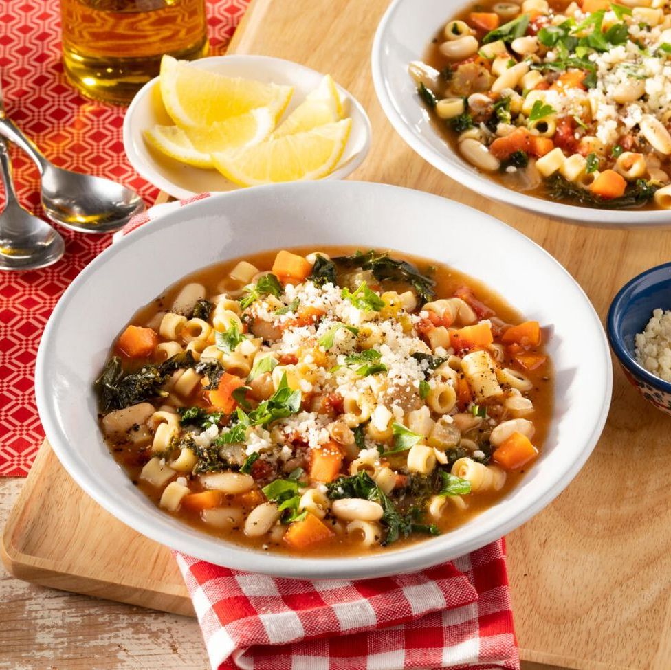 pasta fagioli with lemon wedges and red checkered napkin