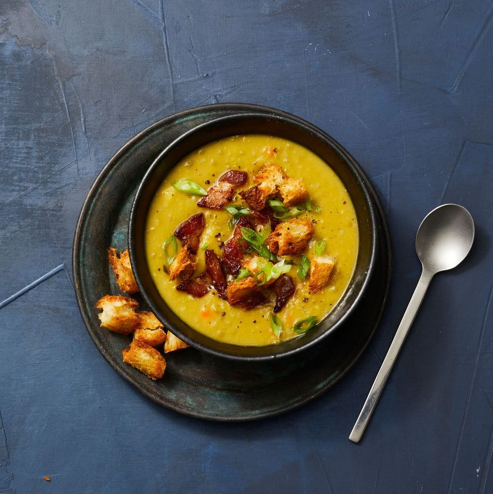 smoky split pea soup with bacon and croutons in a bowl