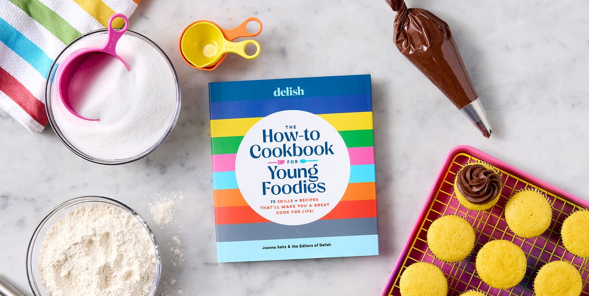 How to Cookbook for Young Foodies how to cookbook for young foodies against a marble surface with a tray of cupcakes, colorful measuring cups and a bowl of flour and sugar
