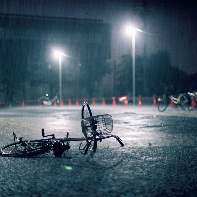 Fallen bicycle in heavy rain.