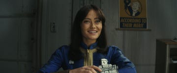 a person smiling and holding a trophy