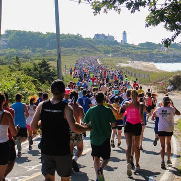 a crowd of runners in a race run on a road along the coast a crowd of runners in a race run on a road along the coast