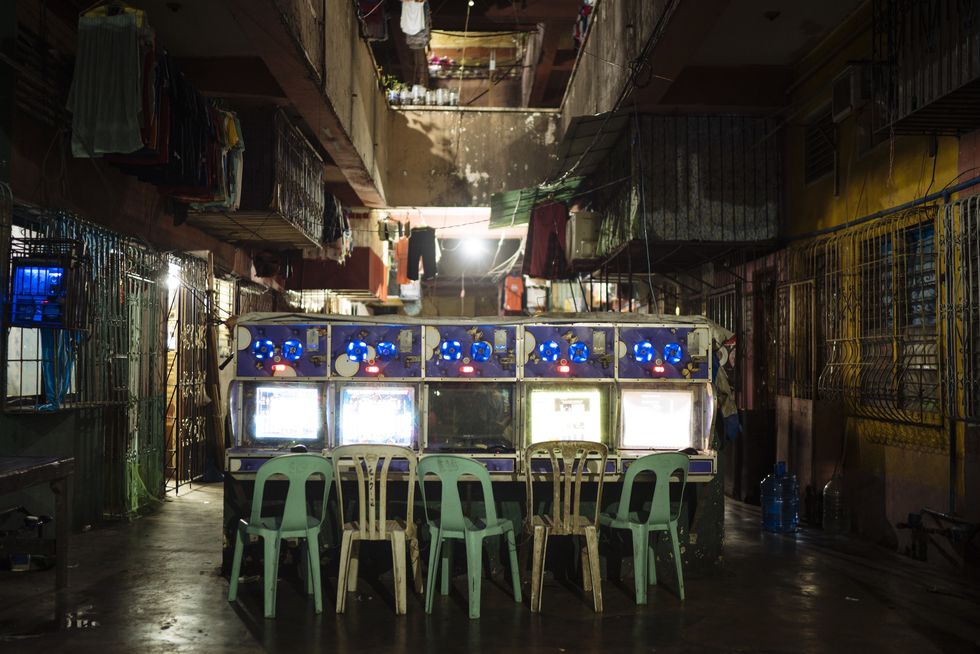 computers with coin slots are seen in a community in manila, where low income filipinos can access the internet for a few minutes for one peso