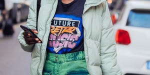 milan, italy   february 23 model maty fall wears a green puffer jacket, blue future retro music t shirt, green acid wash pants, and checks her iphone 11 after the ports 1961 show during milan fashion week fallwinter 2020 2021 on february 23, 2020 in milan, italy photo by melodie jenggetty images