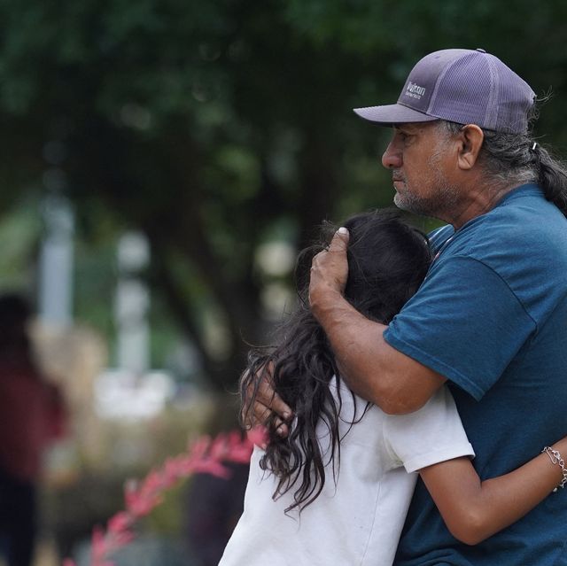 man and little girl hugging in the wake of uvalde shooting