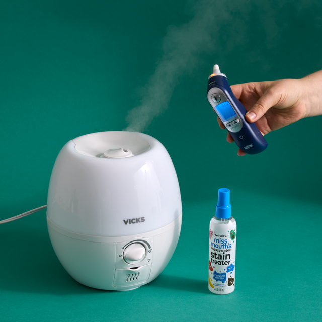 vicks humidifier a digital thermometer and a stain remover spray on a teal background