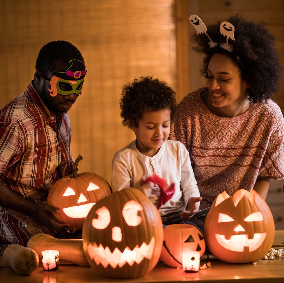 family carving halloween pumpkins