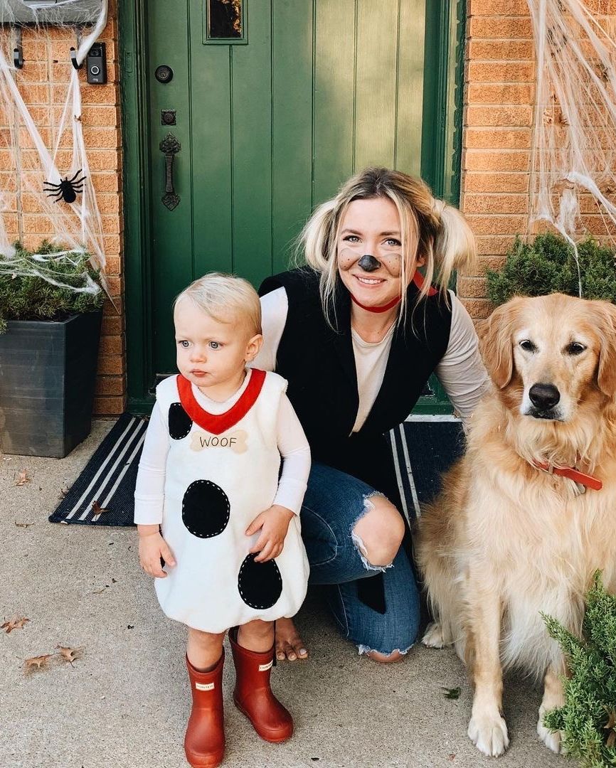daughter in dog dress that says woof, mom in collar with dog makeup and looped ponytails resembling dog ears, and family dog