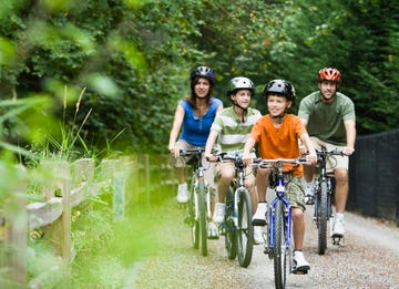 family cycling in park