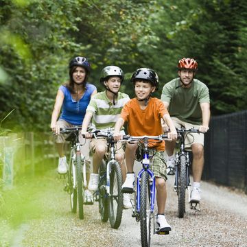 family cycling in park