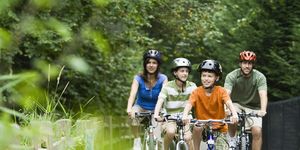 family cycling in park