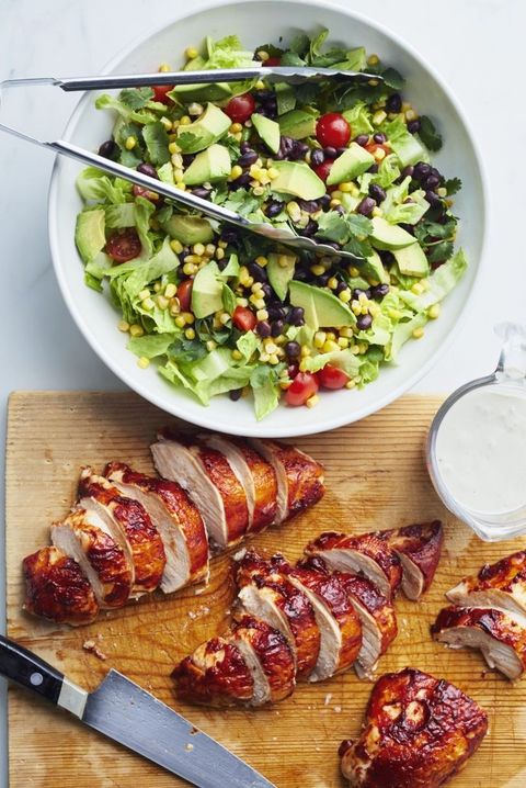 barbecue chicken salad on wood board with salad in bowl