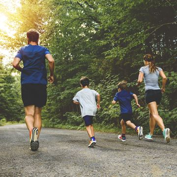 family exercising and jogging together at an outdoor park