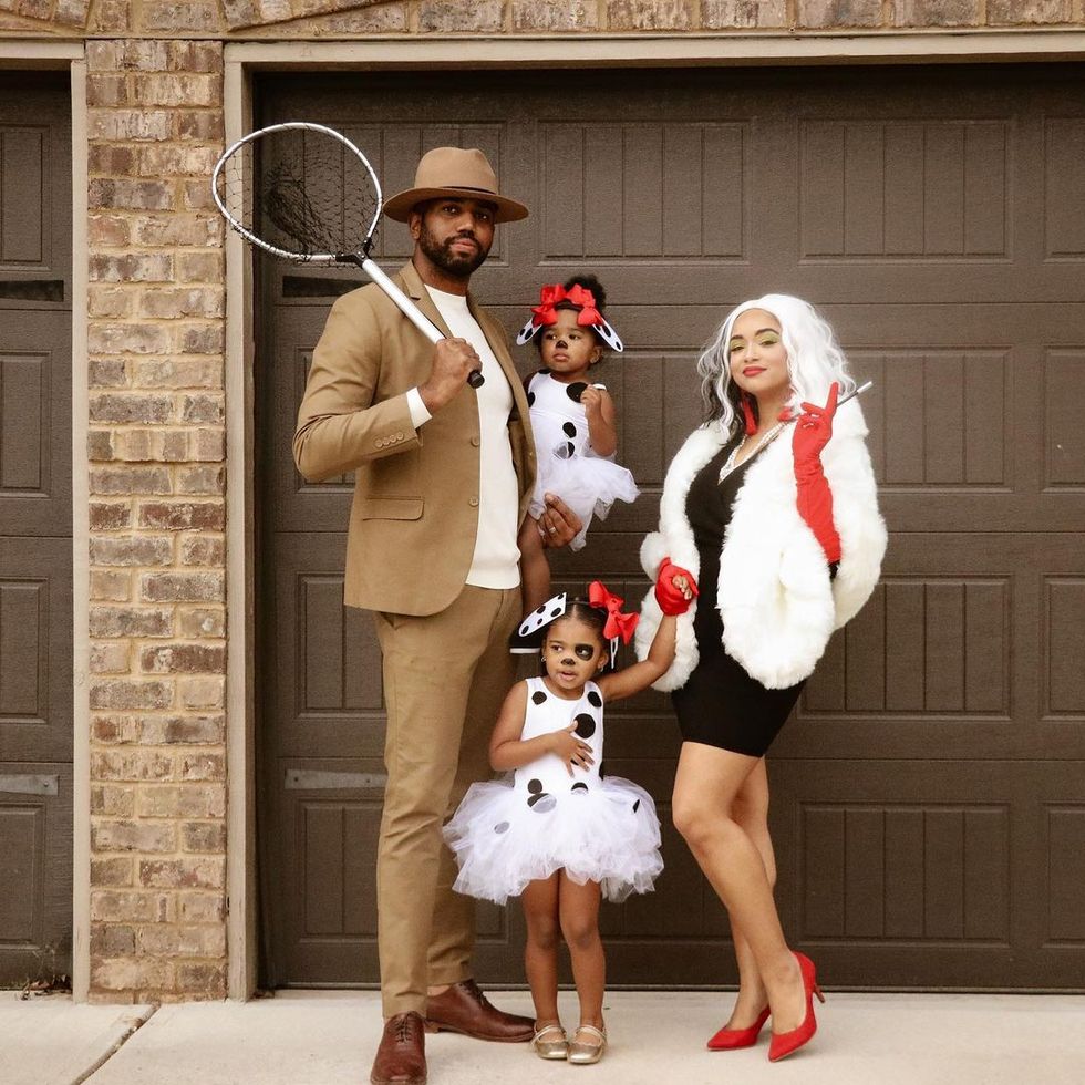family costume idea for 4 with parents as cruella de vil and jasper the henchman and kids as pups from 101 dalmatians