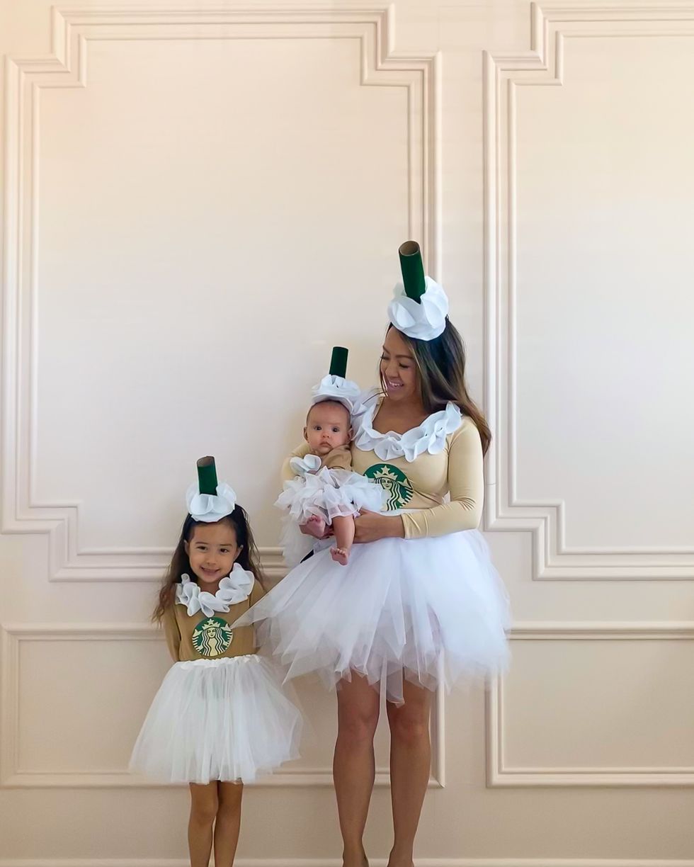mom, daughter and baby in white tutus and tan leotards with giant green drinking straw hats for frappuccino family costume
