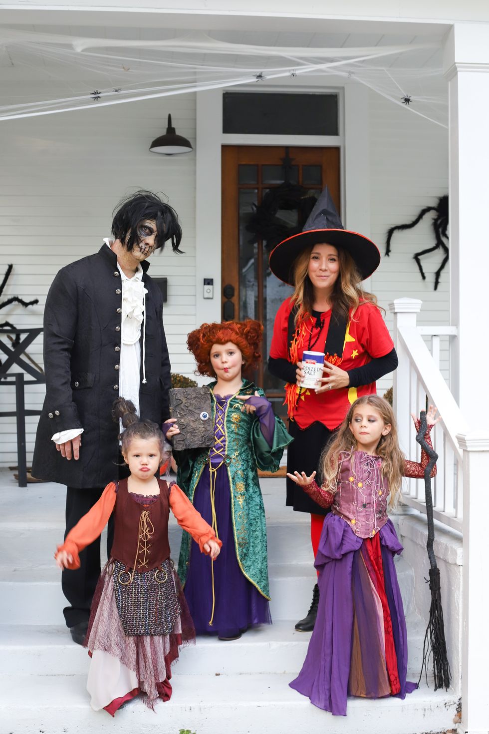 parents and 3 kids dressed as characters from hocus pocus movie for family costume