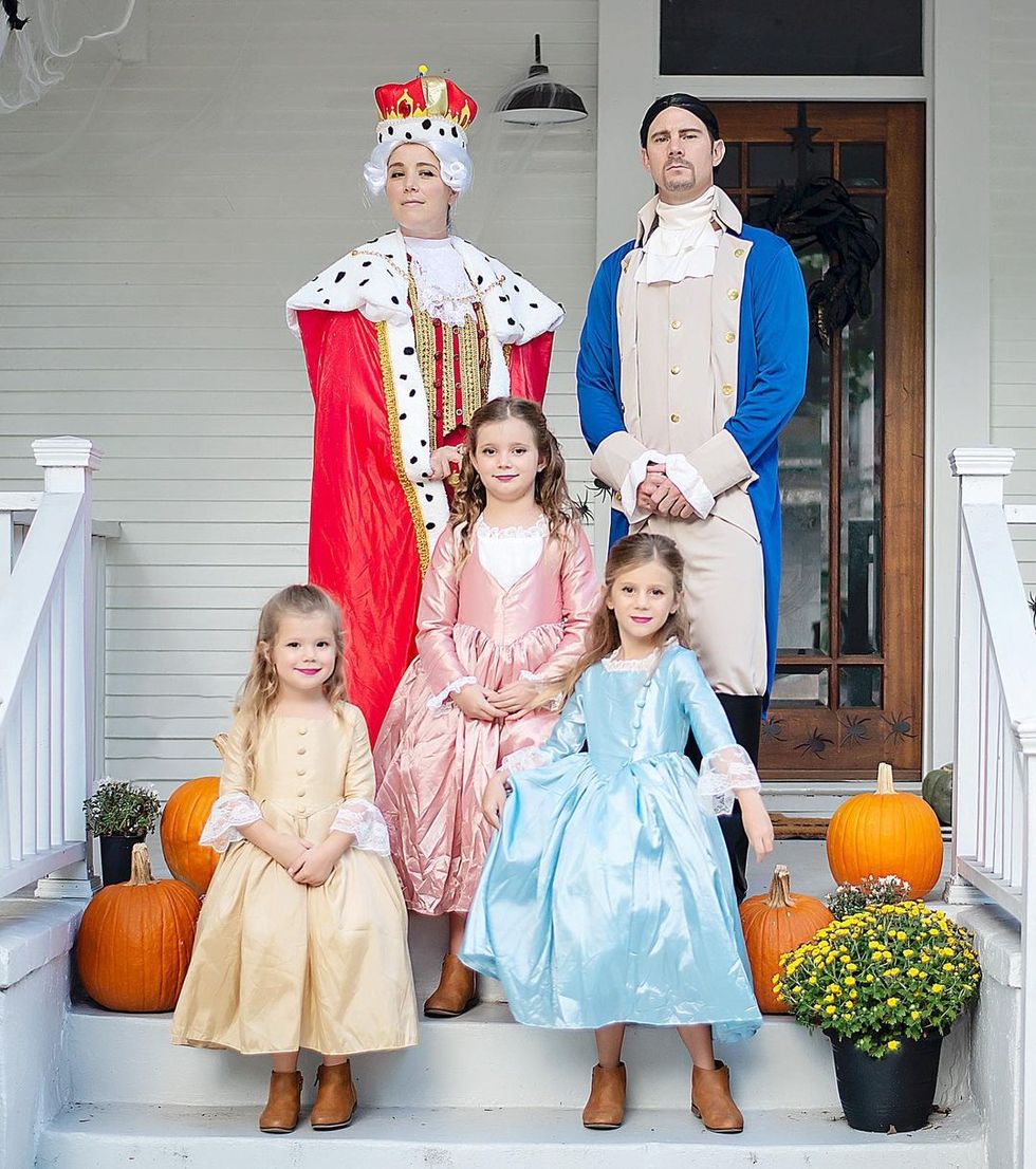 hamilton themed family costume idea for 5 with mom as king, dad as hamilton, and 3 girls in 18th century style dresses