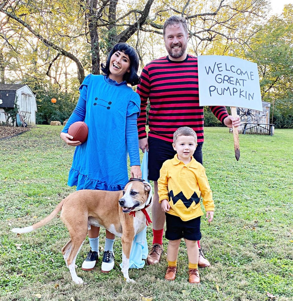 Lucy with a football, Linus with a giant pumpkin sign, Charlie Brown, and a family dressed as Snoopy