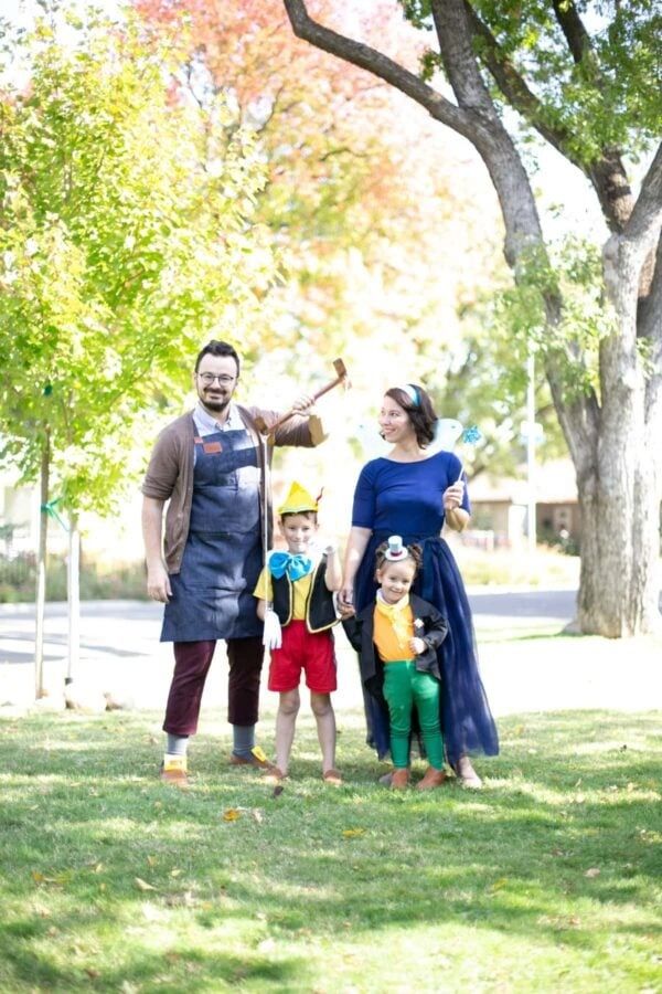 a pinocchio family halloween costume with geppetto, pinocchio, blue fairy and jiminy cricket