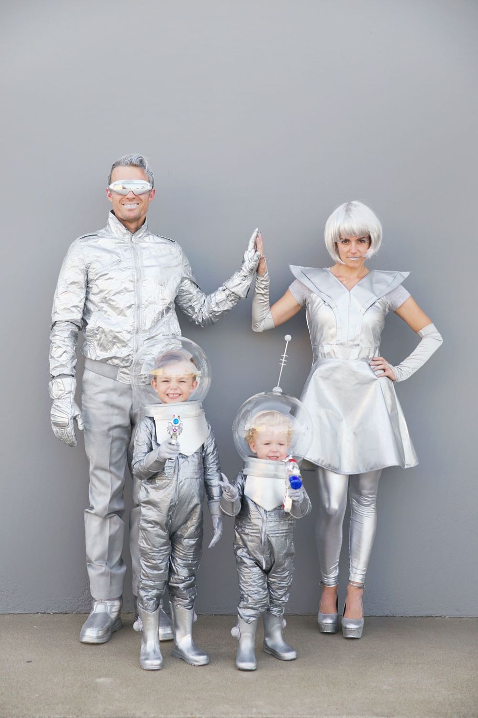 a family dressed up in silver space outfits