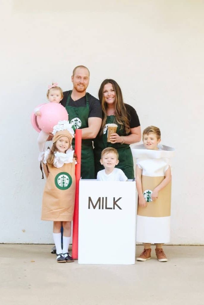 a family dressed in a starbucks group family halloween costume with kids dressed as a coffee, a latte, a milk box and a cake pop plus two parent baristas