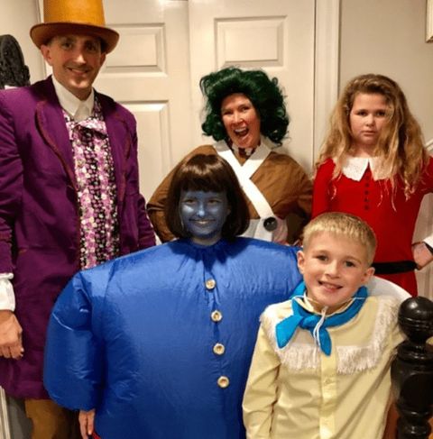 a family halloween costume inspired by 'willy wonka and the chocolate factory' including willy wonka, an oompa loompa, veruca salt, violet beauregard and mike tv