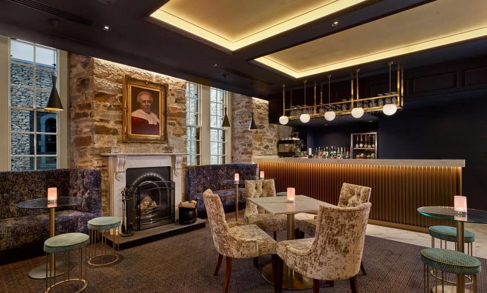 a room with a fireplace and chairs