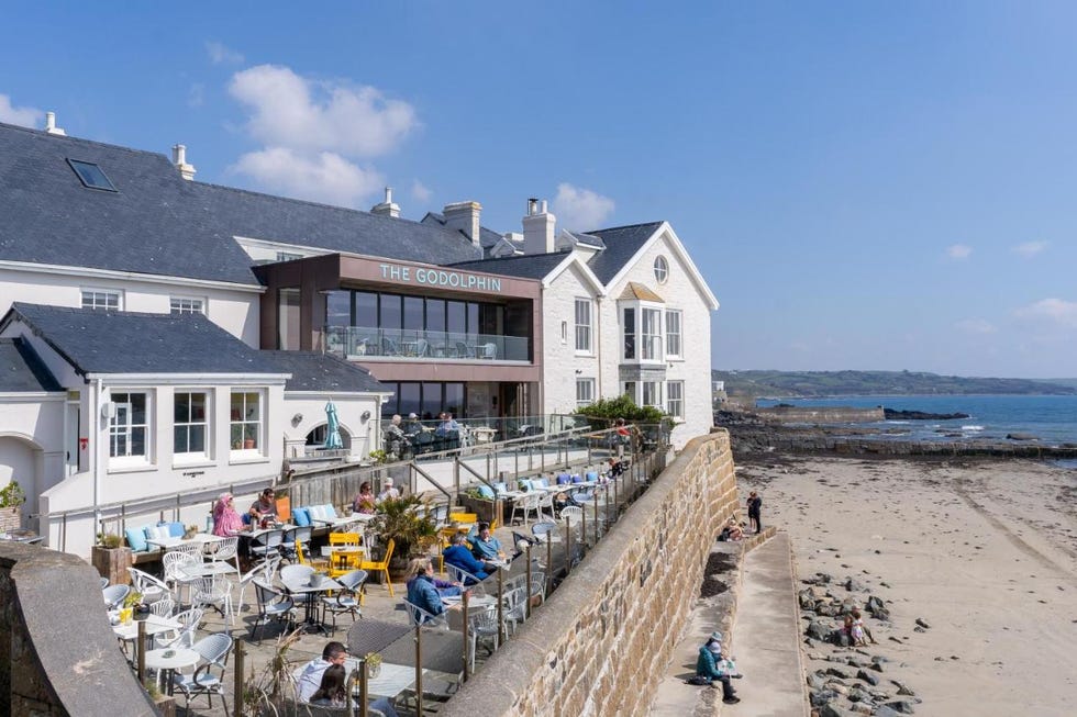 a beach with people and buildings