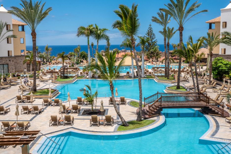 gf gran costa adeje pool with chairs and tables
