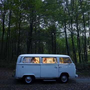 "family in illuminated van in forest, side view, evening" van o camper a noleggio vacanze