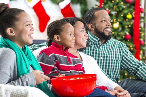 family laughs while watching christmas movie