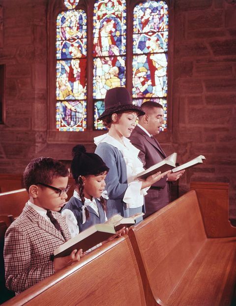 family reading bible in church