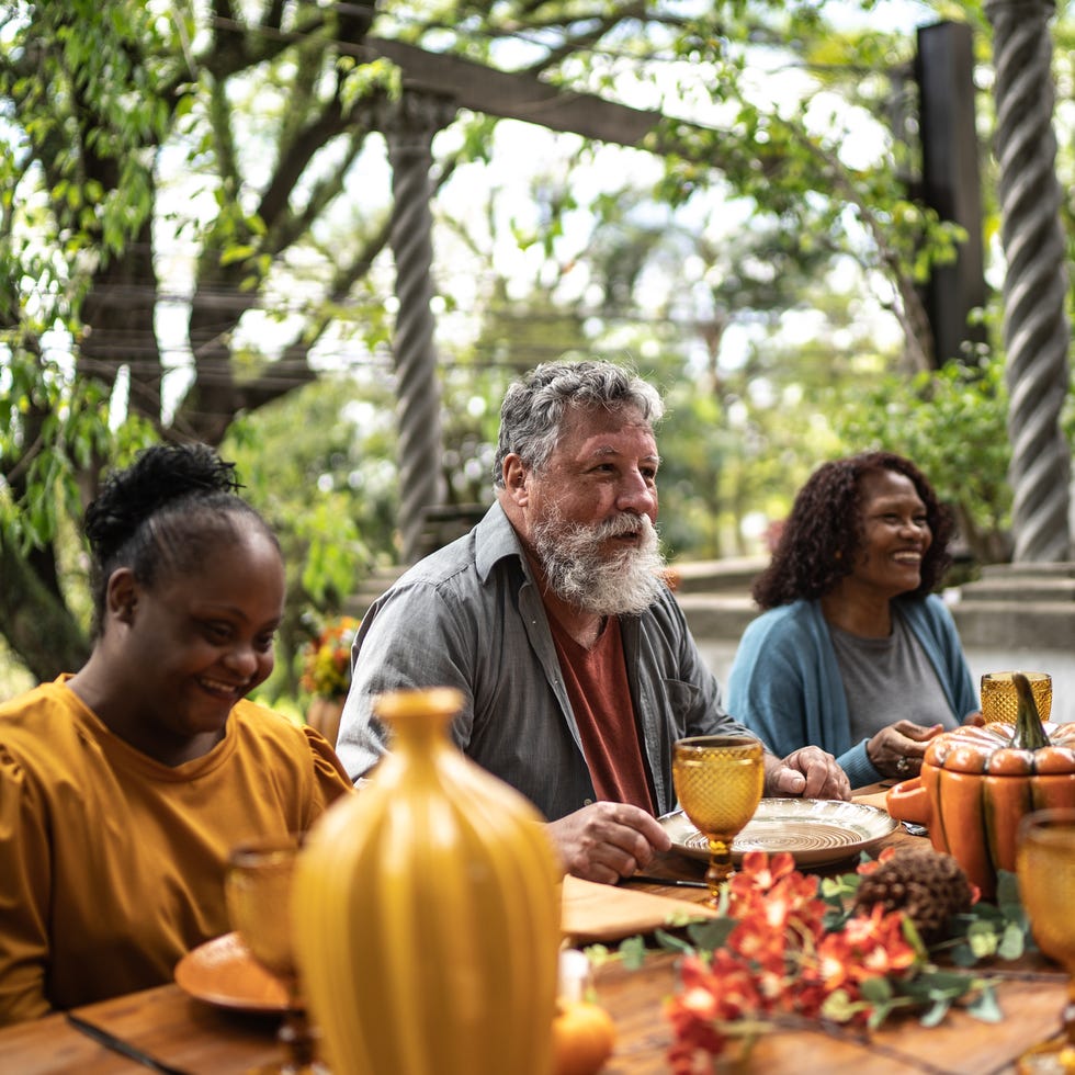 family reunited on the table for thanksgiving at home outdoors