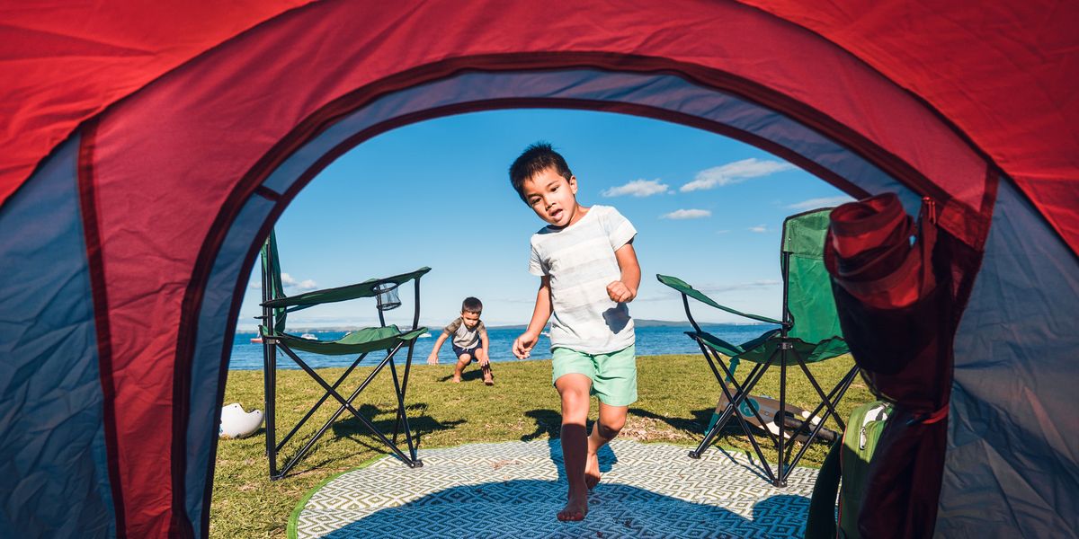 boy running into camping tent