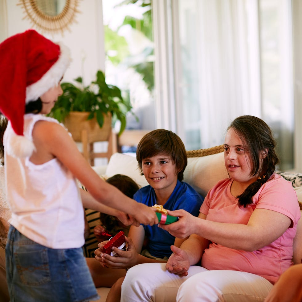 family unwrapping gifts at on christmas morning