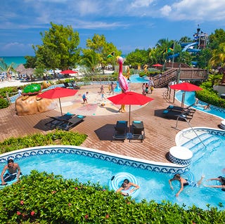 A pool area complete with lazy river at Beaches Negril, a Good Housekeeping pick for best family vacation destination a pool area complete with lazy river at beaches negril, a good housekeeping pick for best family vacation destination
