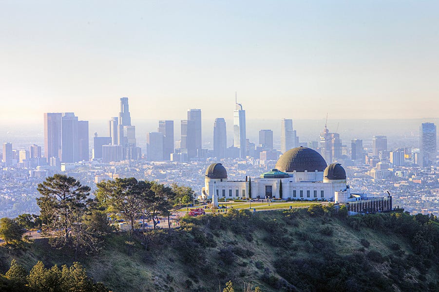 morning scenery of griffith observatory and downtown la los angeles is good housekeeping pick for best family vacation destinations