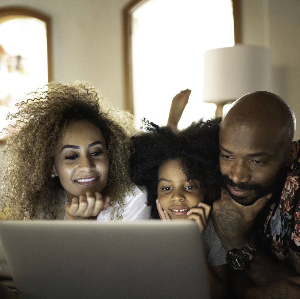 happy family watching movie on a laptop