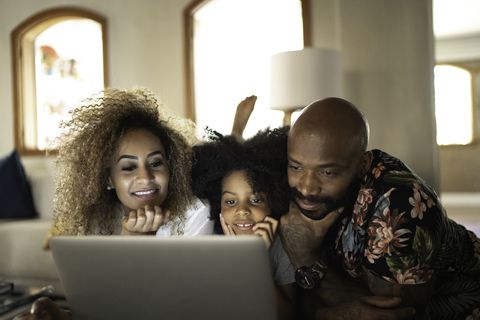 happy family watching movie on a laptop