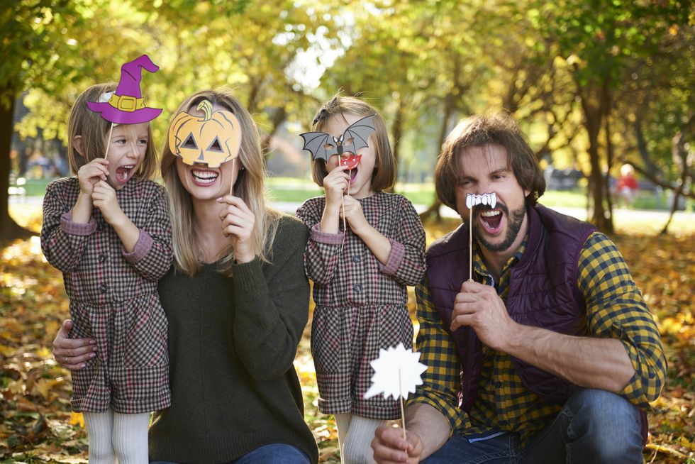 family with halloween photo booth props