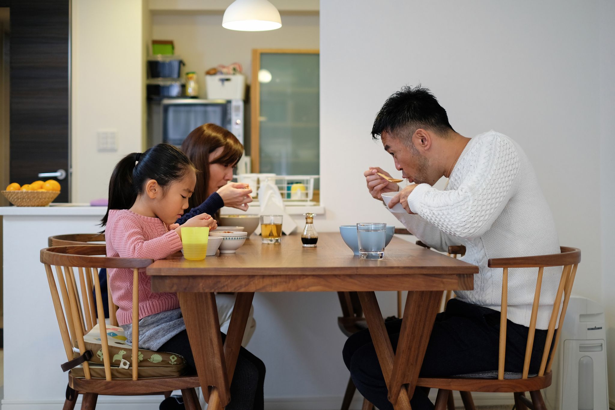 family with one child eating meal in dining room