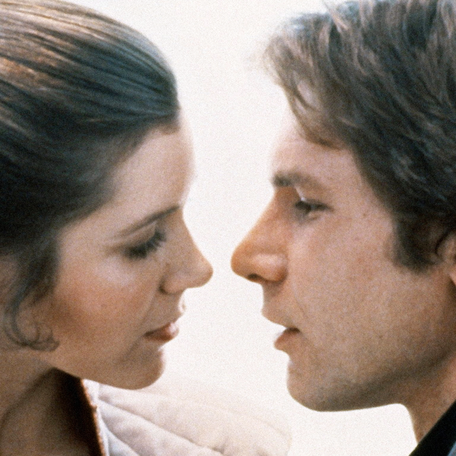 princess leia and han solo about to kiss in a still from star wars