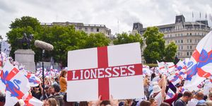 a fan holds a sign in support of the lionesses with the